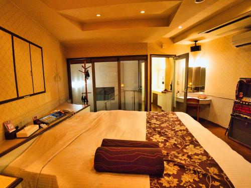 a bedroom with a large bed in a room at SKY Ocean-terace Omura in Omura