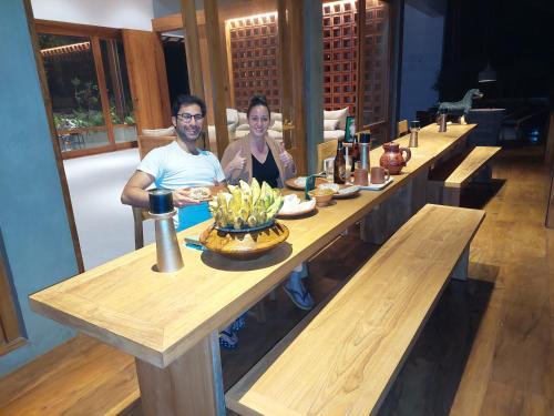 a man and woman sitting at a long table at Paradise Itzu in Kandy