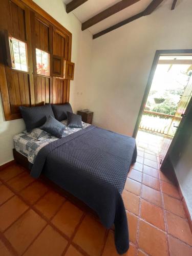 a bedroom with a bed in a room at Hacienda La Tulia Eco Hotel in Toro
