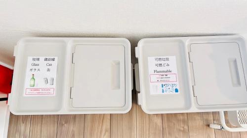 two white containers sitting on top of a wooden floor at Megu Fuji Plus in Fujiyoshida
