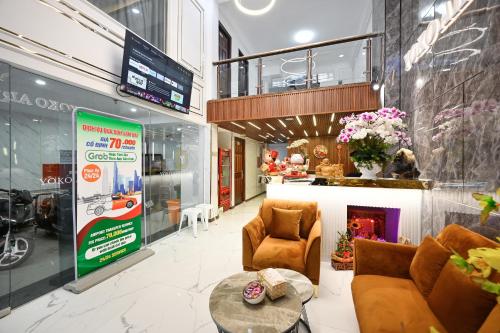 a store with a lobby with chairs and a table at YoKo Airport Saigon Hotel in Ho Chi Minh City