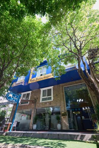 a blue building with trees in front of it at La Palma Boutique Hotel in Ho Chi Minh City