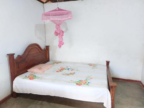 a small bedroom with a bed with at Green Waves HomeStay in Nonagegama