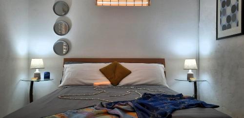 a bedroom with a bed with two lamps on both sides at Breezy Vista on the Terrace - West Coast, Saint James, Barbados in Saint James