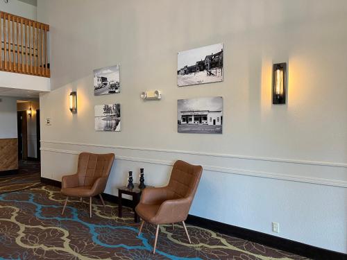 a waiting room with two chairs and pictures on the wall at Crossroads Hotel in McGregor