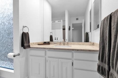 a bathroom with a sink and a large mirror at Private Patio, Close To Pool & Clubhouse Walkable in Scottsdale
