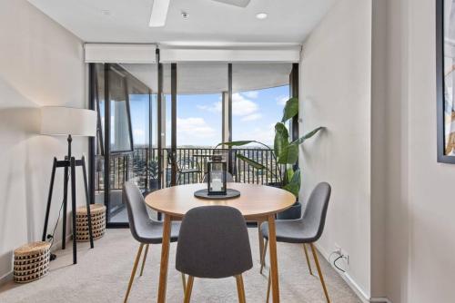 a dining room with a table and chairs and a balcony at Top Floor! 2Bed/2Bath/1Car/Pool ~ VIEWS ~ CBD in Brisbane