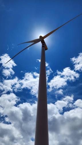 a white windmill in front of a blue at Bougainviella - Sealinks Mũi Né - chuỗi biệt thự liền kề in Phan Thiet