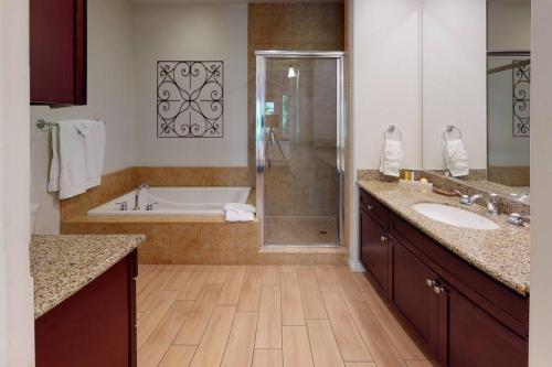 a bathroom with a tub and a sink and a shower at LV101 Downstairs 1 Bedroom Legacy Villas Retreat in La Quinta