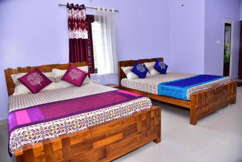 a bedroom with two beds and a couch at Madhuvana Homestay Coorg in Madikeri