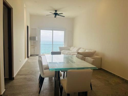 a living room with a table and a couch at Brand new penthouse with plunge pool, amazing top view in Isla Mujeres