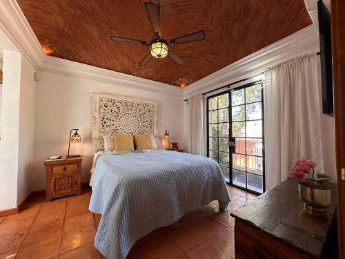 a bedroom with a bed and a ceiling fan at Casa Mona Lisa, a short, level walk to the cathedral in San Miguel de Allende