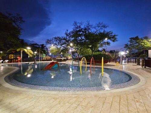 - une petite piscine avec toboggan dans un parc la nuit dans l'établissement Samaria Club de Playa Exclusivo, à Gaira