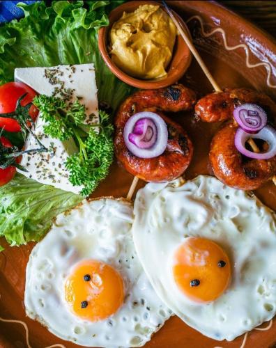 a plate of eggs and other food on a table at Booking Apartment Rajiceva in Belgrade