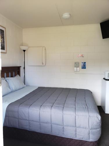 a bedroom with a large bed in a room at Tasman Motor Camp in Tasman