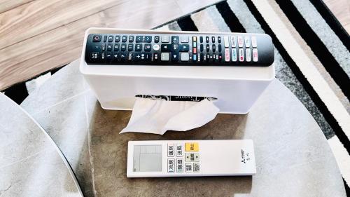 a remote control sitting on top of a scale at Megu Fuji Plus in Fujiyoshida