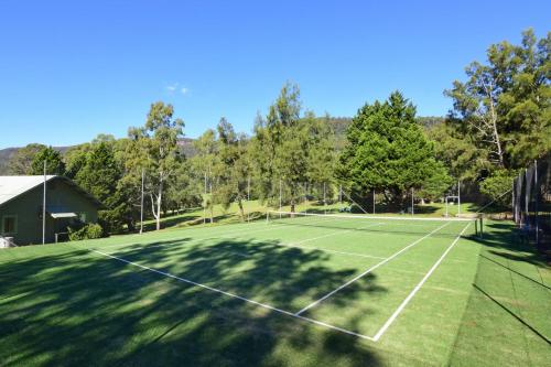 a tennis court with a tennis racket on it at Beau Villa - Two bedroom Villa on golf course in Kangaroo Valley