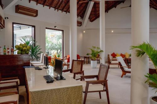 a lobby of a hotel with tables and chairs at Pax Ana Doc Let Resort & Spa in Ninh Hòa
