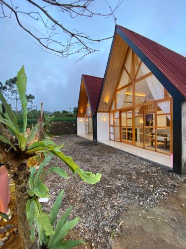 a house with a red roof at Martos villa dieng in Dieng