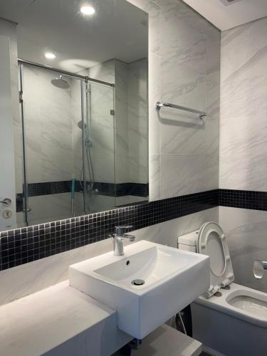 a bathroom with a sink and a shower and a toilet at Luxury econest - Apartment with swimming pool & gym in Hanoi
