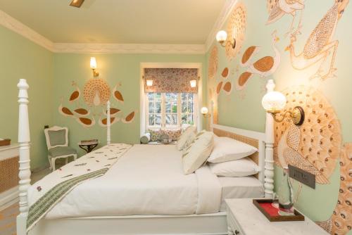 a bedroom with a large bed and a window at Laalee in Jaipur