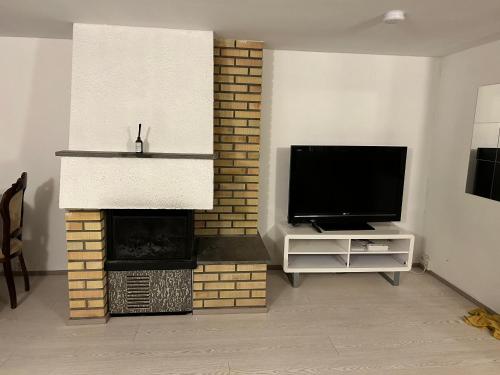 a living room with a television and a fireplace at Beautiful and central apartment in Oslo and Bærum in Kolsås