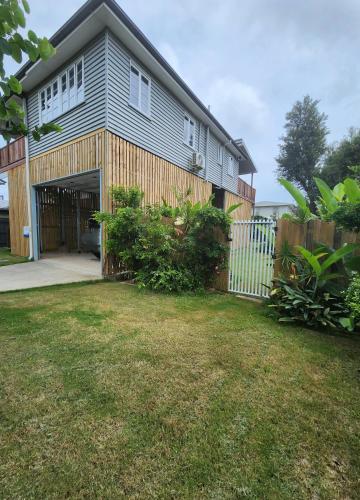 a house with a garage and a fence at OXLEY Mineral Pool & Private Home suburbanSTAY in Brisbane