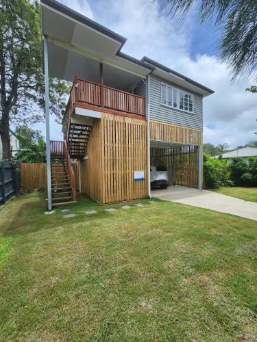 a house with a deck and a staircase at OXLEY Mineral Pool & Private Home suburbanSTAY in Brisbane