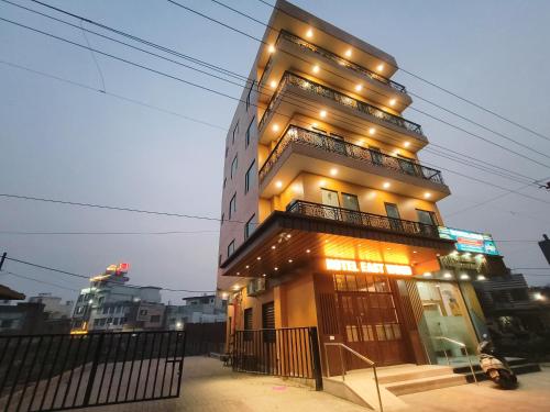 a tall building with lights on top of it at Hotel East Wood Amritsar in Amritsar