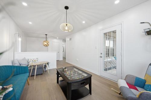 a living room with a couch and a table at Luxury Whitby 4BR, Near Restaurants - Family, Pool Table, Parking! in Whitby