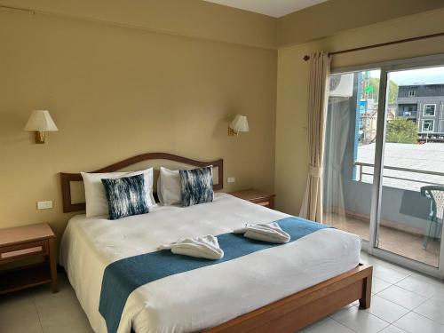 a bedroom with a large bed and a balcony at Lalisa Hotel Aonang in Ao Nang Beach
