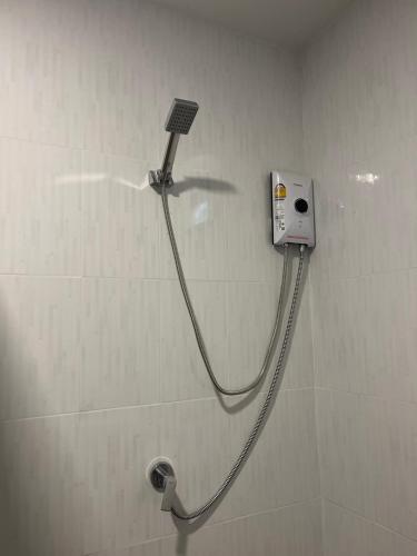 a shower with a hose attached to a wall at Dusit Long Beach in Ko Lanta