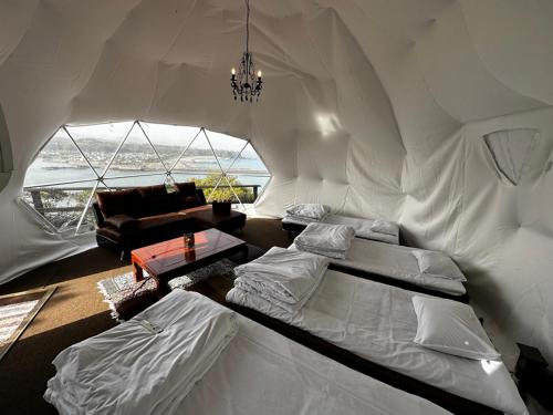 a living room with two beds in a tent at Yamamizuki in Shimanto