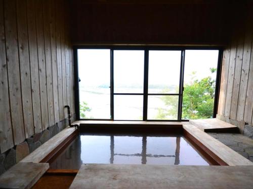 an empty room with a large window and water at Yamamizuki in Shimanto