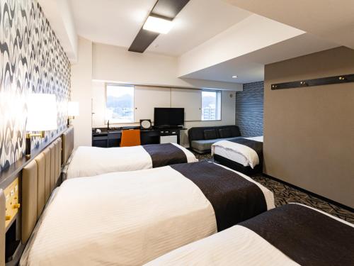 Postel nebo postele na pokoji v ubytování APA Hotel & Resort Sapporo