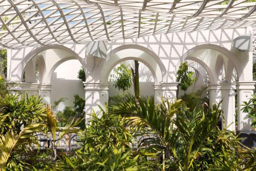 a white building with arches and plants in it at DYORE House by Bharat Mahal Palace in Jaipur