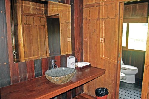 a bathroom with a sink in a wooden bathroom at Ti Amo Bali in Jatiluwih