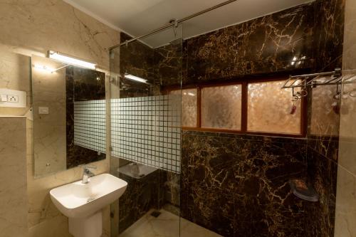a bathroom with a sink and a shower and a toilet at Hotel Akbar At Dal Lake Ghat Number 1 in Srinagar