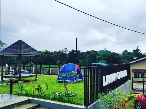 a tent and a gazebo in a yard at Laman Gadang in Johol