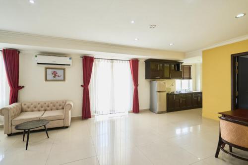 a living room with a couch and red curtains at Bonita Boutique Hotel in Ho Chi Minh City