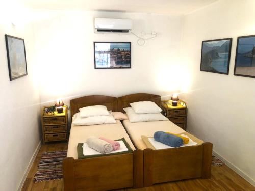 a bedroom with two beds and two night stands at Holiday Home Olivia House in Dobra Voda