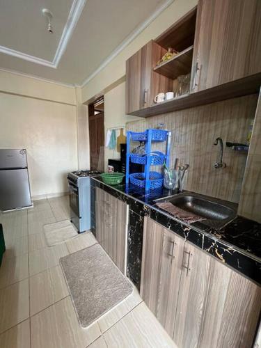 a kitchen with a sink and a counter top at Luxe suite (1bedroom) in Nambale