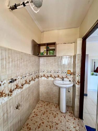 a bathroom with a sink and a shower at Luxe suite (1bedroom) in Nambale