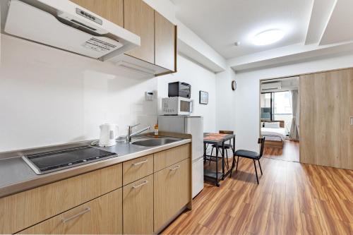 a kitchen with a sink and a counter top at SOLASIA residence 北上野 in Tokyo