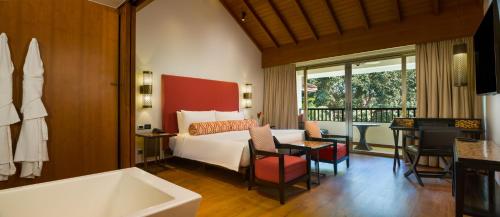 a hotel room with a bed and a bath tub at Alila Diwa Goa - A Hyatt Brand in Majorda