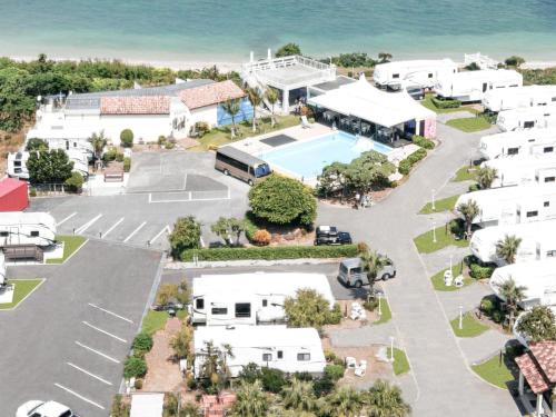 an aerial view of a resort with a tennis court at Wood Pecker Nakijin in Nakijin