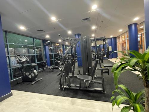 a gym with treadmills and machines in a room at Hotel Diana Woolloongabba in Brisbane