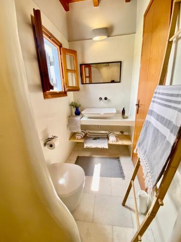 a bathroom with a toilet and a sink and a tub at Plaka Villa 2 Naxos in Plaka