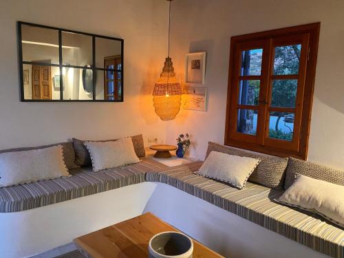 a living room with a couch and a window at Plaka Villa 2 Naxos in Plaka
