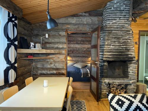 a bedroom with a bed and a stone fireplace at Tohtaja B in Syöte